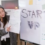 Startup founder presenting funding charts and a startup growth plan to investors