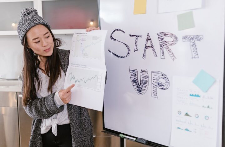 Startup founder presenting funding charts and a startup growth plan to investors